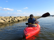 Students paddling around sills and breakwater structures